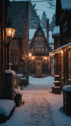 a snowy street lined with wooden buildings and lit up by lights in the snow at night