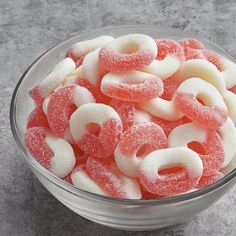 a glass bowl filled with red and white sugar coated pretzels