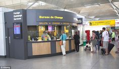 people are waiting in line at the check - in counter for their luggage to be picked up