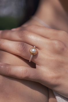 The gold plated Pearl Ring made from Sterling Silver is part of the Pearl Classics and symbolizes the natural beauty and high quality designs of Monika Herré.   The delicate ring band smoothly glides around the finger and is worked into the matt gold plated frame with precision. Monika Herré's characteristic combination of silver and gold brings out the glowing spark of the natural saltwater pearl. The ring can be wonderfully combined with any of the other pieces from the Pearl Classics. It took Modern Pearl Ring, Pearl Rings In Gold, Jewelry Mixed Metals, Ring Pearl Modern, Pearl Ring Design, Gold Bad, Pearl Wedding Ring, Pearl Rings, La Forge