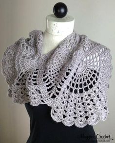 a white crocheted shawl on top of a mannequin headdress