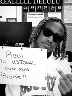 a woman holding up a sign in an office