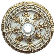 an ornate white and gold plate on a white background