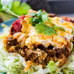 a close up of a plate of food with meat and vegetables on it, including lettuce