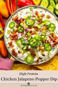 chicken jalapeno pop dip in a bowl surrounded by vegetables