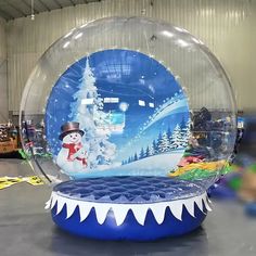 an inflatable snow globe with a christmas scene inside