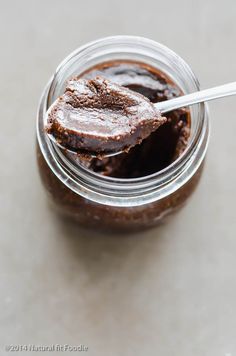 a jar filled with chocolate pudding on top of a table