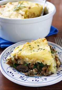 a white and blue plate topped with food next to a casserole dish