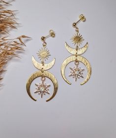 Crescent moon goddess dangle earrings - gold moon phase fewelry for a boho and chic look DETAILS: Metal Material: Stainless Steel and brass accents Length: 6 cm SHIPPING: We strive to dispatch your order promptly, ensuring timely delivery. Estimated delivery times after dispatch: - Netherlands: 1-3 days - Europe: 1-2 weeks - UK: 1-2 weeks - USA: Approximately 3 weeks Gift Wrapping Option: When placing your order, you can choose to have your earrings beautifully gift-wrapped, arriving in a jewelr Celestial Moon Charm Earrings For Festivals, Gold Symbolic Moon Charm Earrings, Gold Moon Phase Symbolic Earrings, Gold Symbolic Moon Phase Earrings, Gold Symbolic Earrings With Moon Charm, Symbolic Gold Earrings With Moon Charm, Celestial Dangle Earrings For Festivals, Celestial Style Dangle Earrings For Festival, Mystical Gold Earrings With Sun And Moon Design