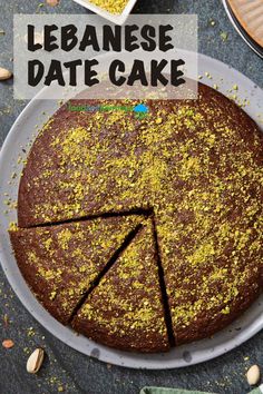 a cake that has been cut into pieces and is on a plate with the words, lebanse date cake