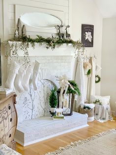 a living room decorated for christmas with stockings hanging from the fireplace and stockings on the mantle