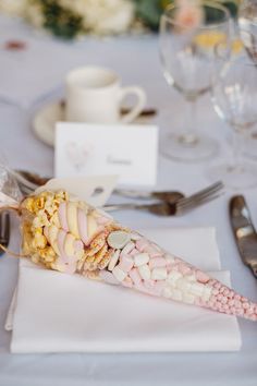 a white table with silverware and napkins on it