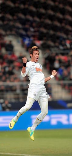 a man in white uniform running across a field