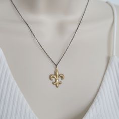 This timeless New Orleans inspired necklace features the classic fleur de lis design on an antique brass pendant, carefully crafted from an original vintage dye cast. Choice of 14K gold dipped or antique brass chain. Choice of 16" or 18" length. Spring ring closure. Pendant measures 1" in length. Antique Brass Pendant, Mixed Metal Bracelets, Mixed Metal Earrings, Silver Jewelry Necklace, Inspired Necklace, Brass Bracelet, Brass Necklace, Gold Dipped, Brass Pendant