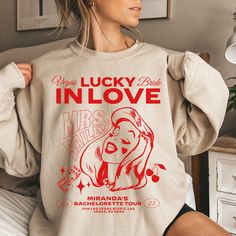 Lucky In Love Vegas Bride, Vegas Bachelorette, Vegas Bachelorette Shirts, Vegas Bachelorette Itinerary, Las Vegas Bachelorette Sweatshirt Ride into sin city before settling down as a wife! Customize this lucky shirt with your new last name, first name and address of choice! This can be the address you and your bachelorette squad will be staying while partying it up in Vegas. The Cosmopolitan? Ceasars Palace? The Venetian? You personalize it! Cheers and anything that happens in Vegas, stays in Vegas! ABOUT THE SWEATSHIRT👕 Ideal for any situation, a unisex heavy blend crewneck sweatshirt is pure comfort. These garments are made from polyester and cotton. This combination helps designs come out looking fresh and beautiful. The collar is ribbed knit, so it retains its shape even after washing Vegas Bachelorette Party Itinerary, Vegas Bachelorette Decor, Bachelorette Party Sweatshirts, Lucky In Love Bachelorette Party, Vegas Bachelorette Itinerary, Vegas Bachelorette Shirts, Bachelorette Squad, Ceasars Palace, Bachelorette Vegas