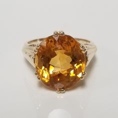 "Thanks for shopping our vintage estate store. We tend to sell well below wholesale and truly hope you enjoy all of our items. Many of the items are one of a kind, so please enjoy scrolling through the pictures and hopefully something will catch your eye. Black spots are from camera or reflections. Estate 14k yellow gold natural 6ct citrine honey lemon oval cut cocktail ring.  Ring size: 8 Setting: 12.9mm 1/2\" by 15mm 5/8\" Gem: 14mm by 11mm Band width: 2mm  Weight: 7.33 grams Beautiful ring, marked 14k. Gem testing natural, but may be created." Baltic Amber Jewelry, Honey Lemon, Eternity Band Ring, Natural Citrine, Amber Jewelry, Cute Rings, Black Spot, Beautiful Ring, Hair Pin