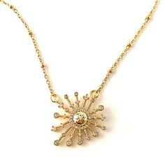 A golden pave sunburst focal on a stainless-steel gold chain. Elegant Gold Starburst Necklace, Elegant Gold Starburst Jewelry, Elegant Starburst Sun Design Jewelry, Elegant Sun Design Starburst Jewelry, Elegant Gold Sunburst Jewelry, Elegant Gold Plated Sun Design Necklace, Sunburst Necklace, Charm Necklaces, Gold Chain