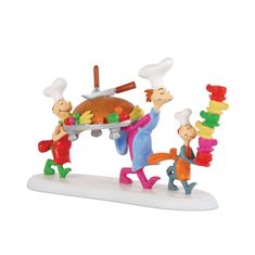 three figurines are carrying a turkey on a platter, and one is holding a spatula