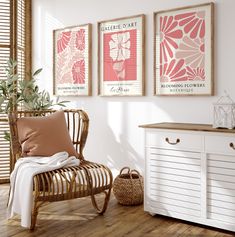 a room with three framed pictures on the wall and a wicker chair next to it