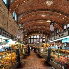 an indoor market with people shopping in it