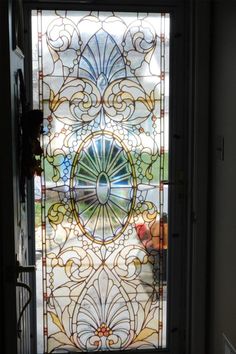 a glass door with an intricate design on it