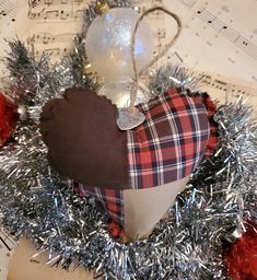 a heart shaped decoration on top of sheet music