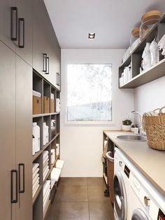 a washer and dryer in a small room with lots of shelves on the wall