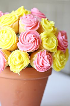 cupcakes with pink and yellow frosting in a vase