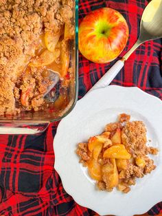 an apple crumbler next to a dish of baked apples on a plaid tablecloth