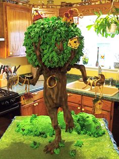 a cake made to look like a tree with leaves on it's head and hands