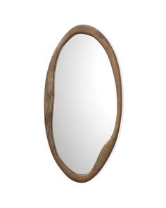 an oval wooden mirror hanging on the wall