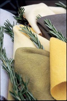 several different colored napkins with pine needles on them