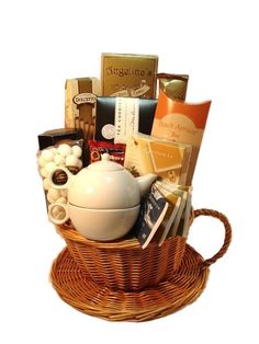 a tea pot filled with assorted items in a wicker basket on top of a table