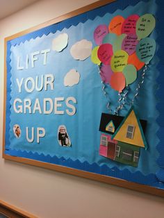 a bulletin board with balloons attached to it and the words let your grade up written on it