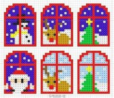 four cross stitch christmas decorations with snowman, dog and tree in the window sill