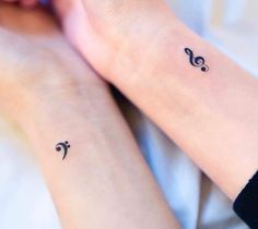 two people with matching tattoos on their arms