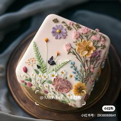 a cake decorated with flowers and butterflies on a plate