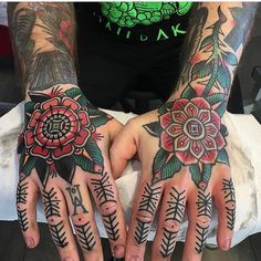 two hands with tattoos and flowers on them