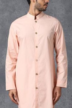 Peach kurta with mandarin collar. Comes with churidar.
Components: 2
Fabric: Cotton
Neckline: Band collar
Sleeve Length: Full
Color: Peach
Closure: Front button placket on kurta - Aza Fashions Festive Kurta With Button Cuffs, Men Kurta, Kurta With Pants, Band Collar, Churidar, Pant Set, Mandarin Collar, Aza Fashion, Button Placket