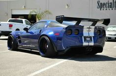 a blue sports car parked in a parking lot