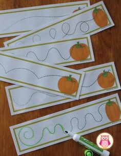 four pumpkins cut out on paper with markers