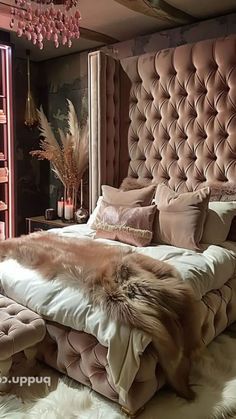 a large bed sitting in the middle of a bedroom next to a tall book shelf