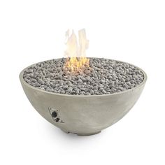 an outdoor fire pit with rocks on the bottom and flames coming out of it's sides