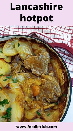 a pot filled with meat and potatoes on top of a table