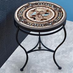 a small table with a mosaic design on it