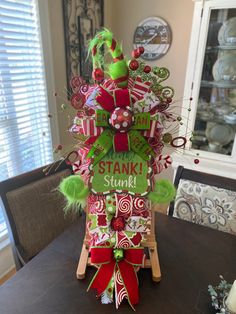 a christmas decoration on top of a wooden sleigh with candy canes and candies