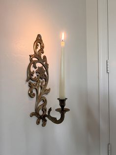 a candle that is on the wall next to a light