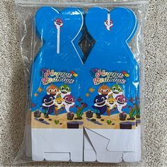 there are two blue birthday candles in the package