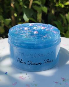 blue ocean floss in a plastic container on a table