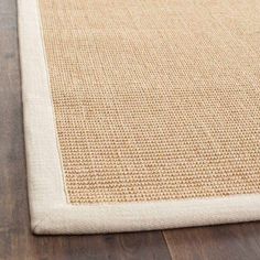 a close up view of the bottom of a rug on a wooden floor with wood floors